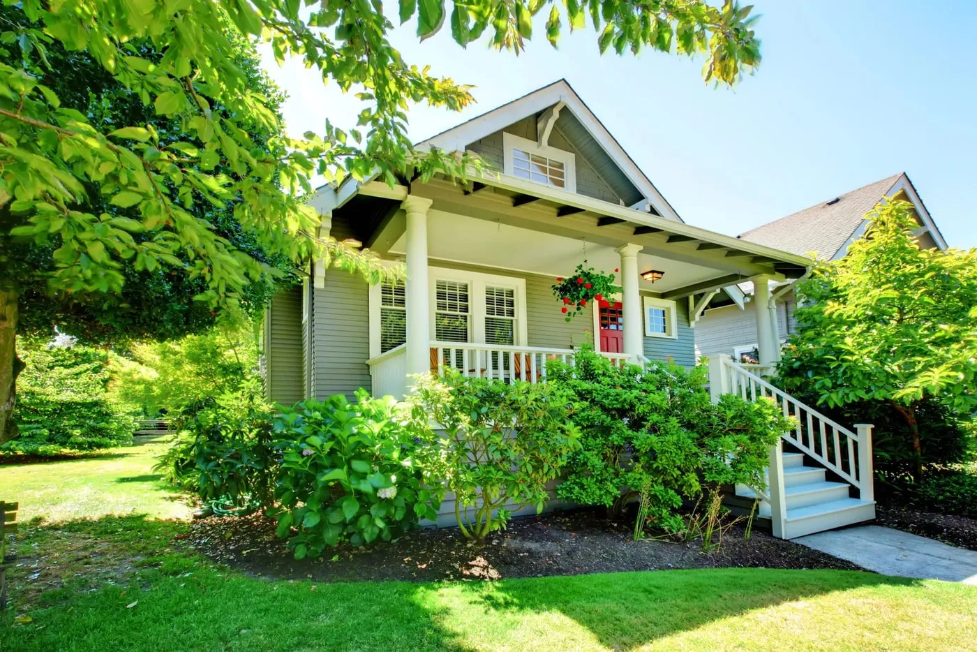 Well-kept home framed by healthy, freshly maintained trees and a green lawn